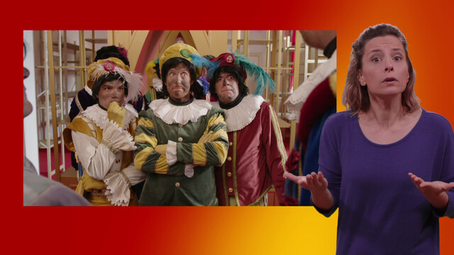 Pieten halen hun schouders op in de pakjeskamer. Naast het scherm staat de gebarentolk.